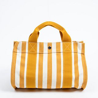 Hermes Cannes PM Handbag, in orange and ivory striped canvas with silver hardware, opening to a matching canvas lined interior with an attached orange