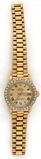 Lady's 18K Yellow Gold Lady's Oyster Perpetual Rolex Date Wristwatch, with a diamond mounted bezel and original Rolex 18K yellow gold band, the bezel 