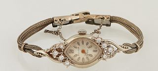 Vintage Lady's 14K White Gold and Diamond Bulova 23 Wristwatch, Serial # 114805, the lugs mounted with four small round diamonds, H.- 1 1/2 in., W.- 5