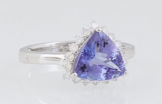 Lady's 18K White Gold Dinner Ring, with a 2.1 ct. trillion cut tanzanite atop a conforming border of small round diamonds, total diamond wt.- .33 cts,
