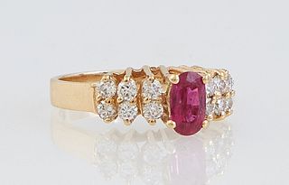 Lady's 14K Yellow Gold Dinner Ring, with an oval app. 1/2 carat ruby, flanked by three rows of two round .05 carat diamonds, total diamond wt.- app. .