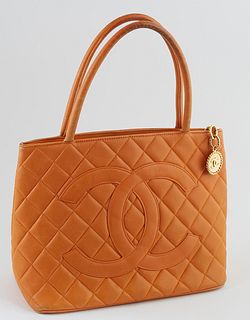 Chanel Mandarine Caviar Quilted Leather Medallion Shoulder Bag, with large "CC" logo sewn on front and golden brass zip chain with "CC" logo, opening 