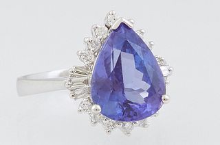 Lady's 18K White Gold Dinner Ring, with a 4.63 ct. pear shaped tanzanite atop a border of round and baguette diamonds, total diamond wt.- .36 cts., Si