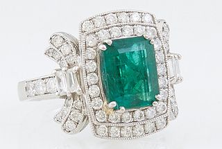 Lady's Platinum Dinner Ring, with a 2.34 carat emerald atop a stepped graduated border of round diamonds, flanked by baguette diamond mounted lugs and
