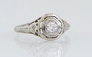 Vintage Lady's 18K White Gold Dinner Ring, with an octagonal top with a central .5 carat round diamond, the band stamped "Rost," the shoulders of the 