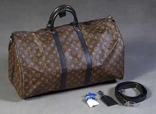 Louis Vuitton Travel Bag, in brown monogram coated canvas with black leather accents and gunmetal hardware, opening to a dark brown canvas lined inter