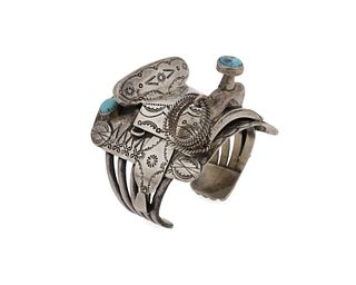 A silver saddle cuff bracelet with turquoise pommel