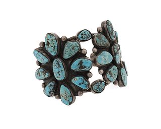A large silver and turquoise cluster bracelet