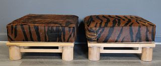 A Pair Of Hide Upholstered Ottomans