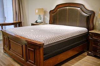 King Size mahogany bed with brown leather insert in headboard