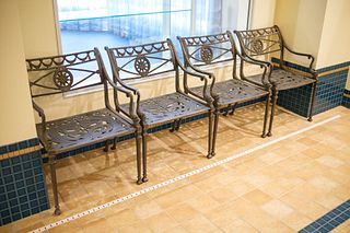 Set of (4) cast aluminum patio chairs with dolphin arms