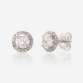 A pair of diamond and eighteen karat white gold earrings