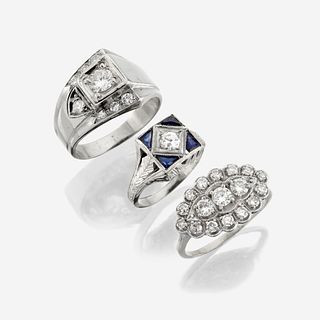 A collection of three white gold and diamond rings