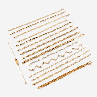 A collection of sixteen fourteen karat gold bracelets
