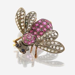 A silver topped gold, ruby, diamond, and sapphire brooch