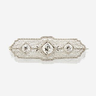 A diamond and ten karat white gold brooch