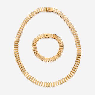 An eighteen karat gold necklace and matching bracelet