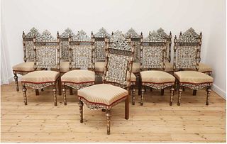 A set of twelve walnut, bone and mother-of-pearl inlaid dining chairs,