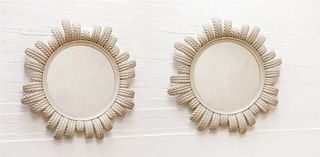 A pair of modern circular mirrors,