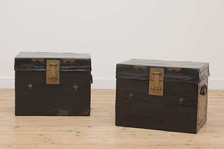 A pair of lacquered leather trunks,