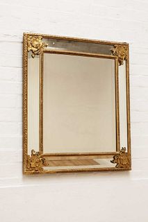 A gilt-framed wall mirror,
