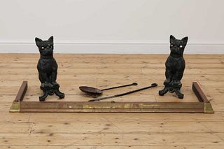 A pair of cast iron French bulldog firedogs,