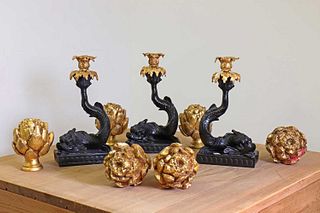 A set of three rococo-style composite and gilt-metal candleholders,