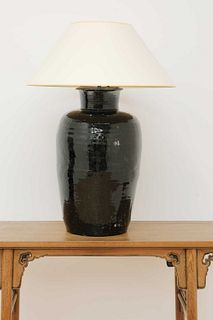 A large treacle-glazed pottery table lamp,