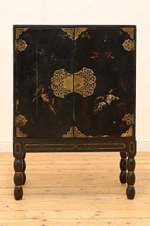 A black-lacquered cabinet on stand,