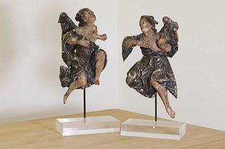 A pair of carved limewood and polychrome painted wooden figures of angels,