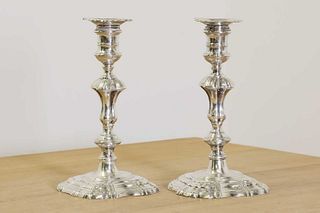 Two George II cast silver candlesticks,