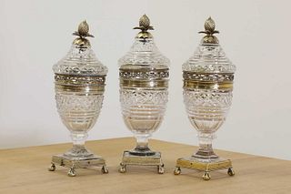A set of three cut-glass and silver gilt cups and covers,