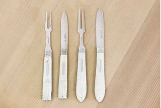 Two pairs of silver and mother-of-pearl folding fruit knives and forks,