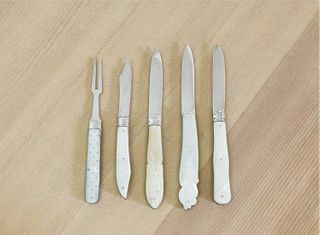 Four silver and mother-of-pearl folding fruit knives and a fork,