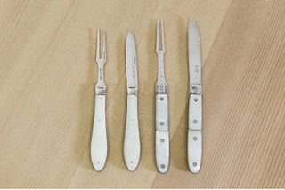 Two pairs of silver and mother-of-pearl folding fruit knives and forks,