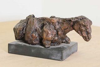 A bronze of a reclining sheep,