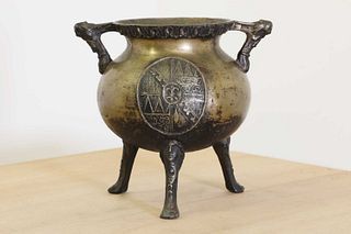 A cast brass tripod cauldron,