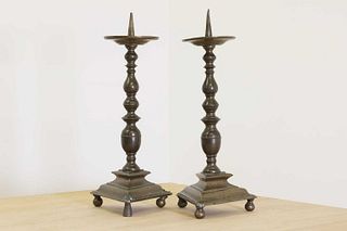 A pair of bronze pricket candlesticks,