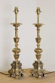 A pair of cast brass altar candlestick lamps,