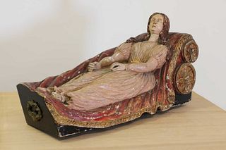 A polychrome painted wooden figure of a reclining female,