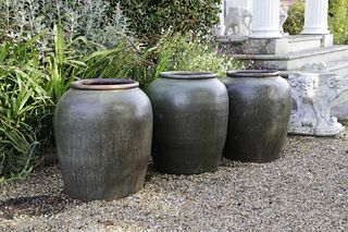 Three large terracotta green-glazed jars,