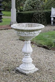 A carved marble pedestal font,