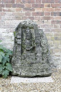 A carved lava stone figural group,