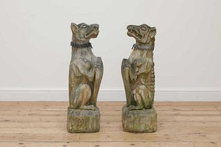 A near pair of composite stone guardian dogs,