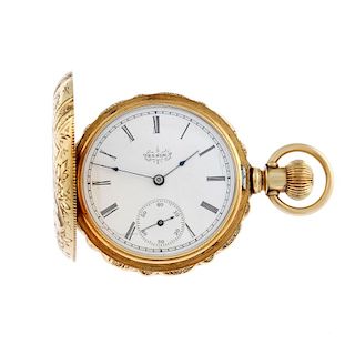 A full hunter pocket watch by Elgin. Yellow metal case with engraved bird and flower detail, stamped