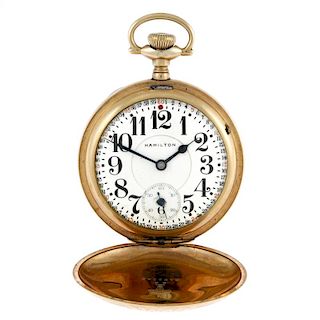 A full hunter pocket watch by Hamilton. Gold plated case with decoration and an engraved cartouche t