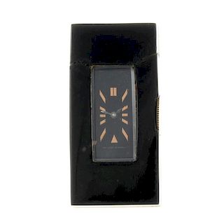 A domino clock by Van Cleef & Arpels. Onyx case with domino style case back depicting the Jack of Cl
