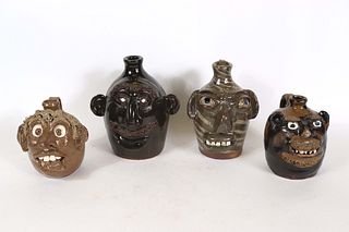 Group of Four Stoneware Face Jugs