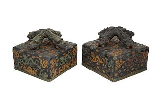 A pair of large Chinese-style terracotta paperweights
