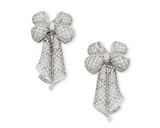A pair of diamond bow ear pendants